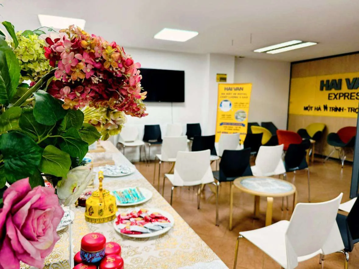 Inside the Hai Van lounge: a table of tea, snacks and fruit beside rows of seating